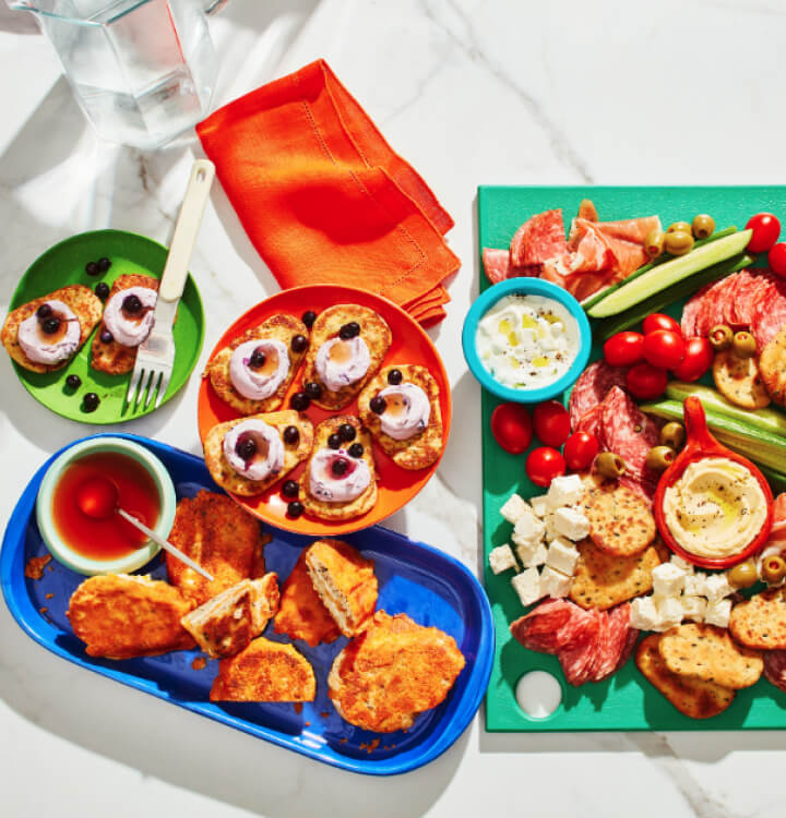 Buffalo chicken mac n cheese baked potatoes, cheeseburgers, and nachos on a blue background