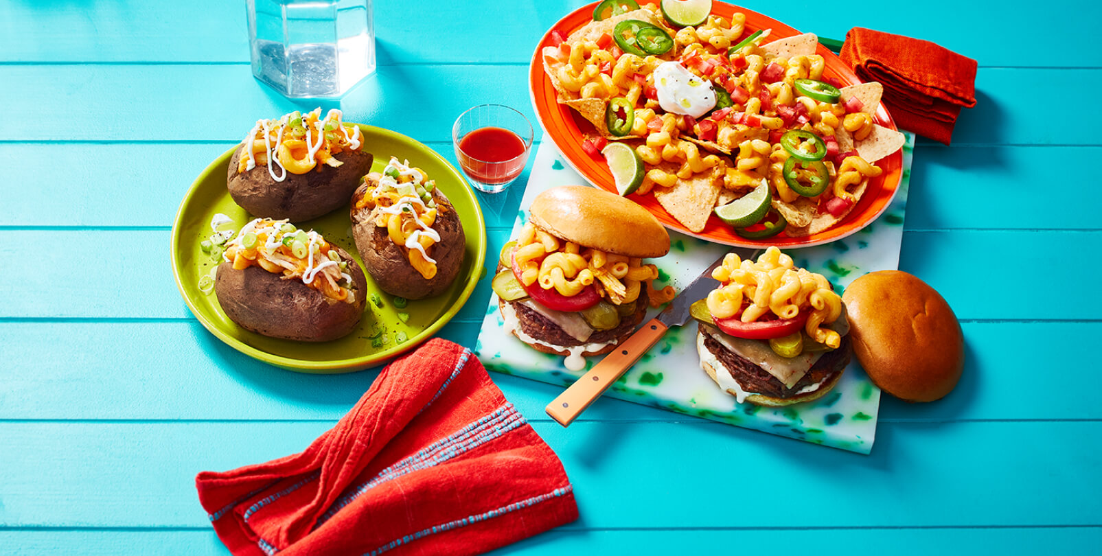 Buffalo chicken mac n cheese baked potatoes, cheeseburgers, and nachos on a blue background