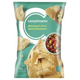 Green package of Compliments Restaurant Style Tortilla Chips