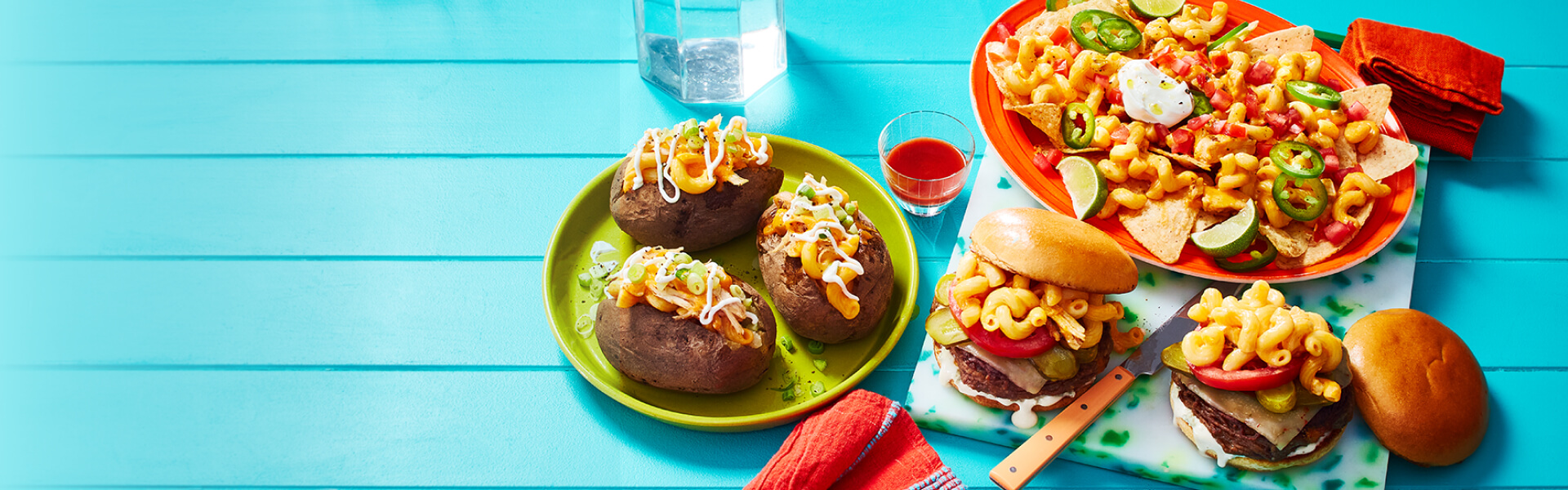 Buffalo chicken mac n cheese baked potatoes, cheeseburgers, and nachos on a blue background